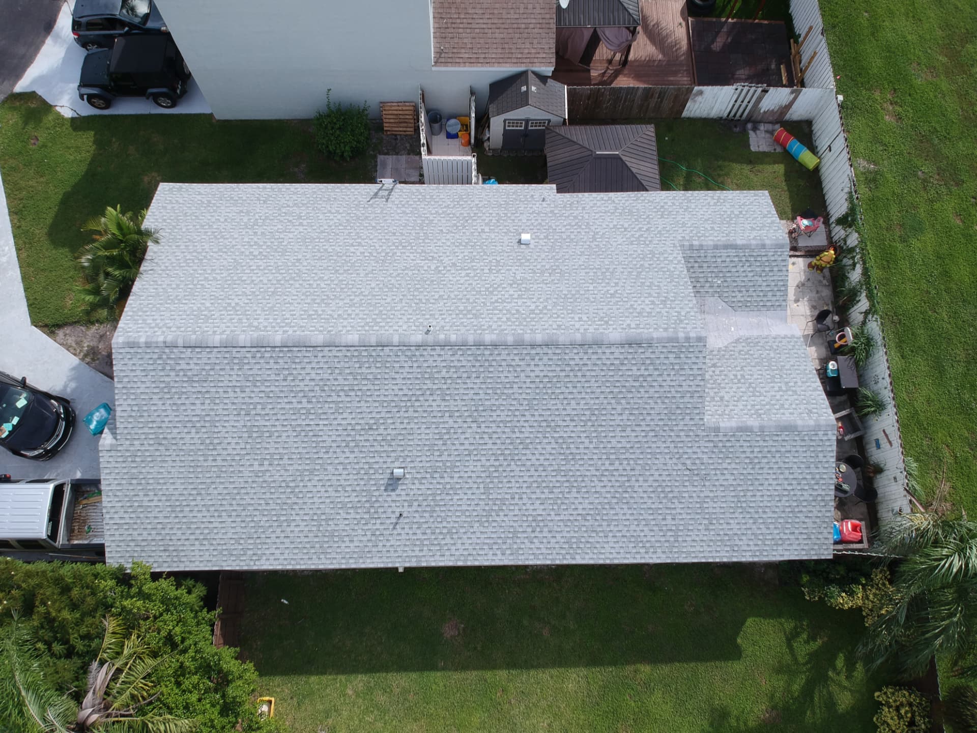 Overhead view of a finished shingle roof with clean ridge lines and vent detailing