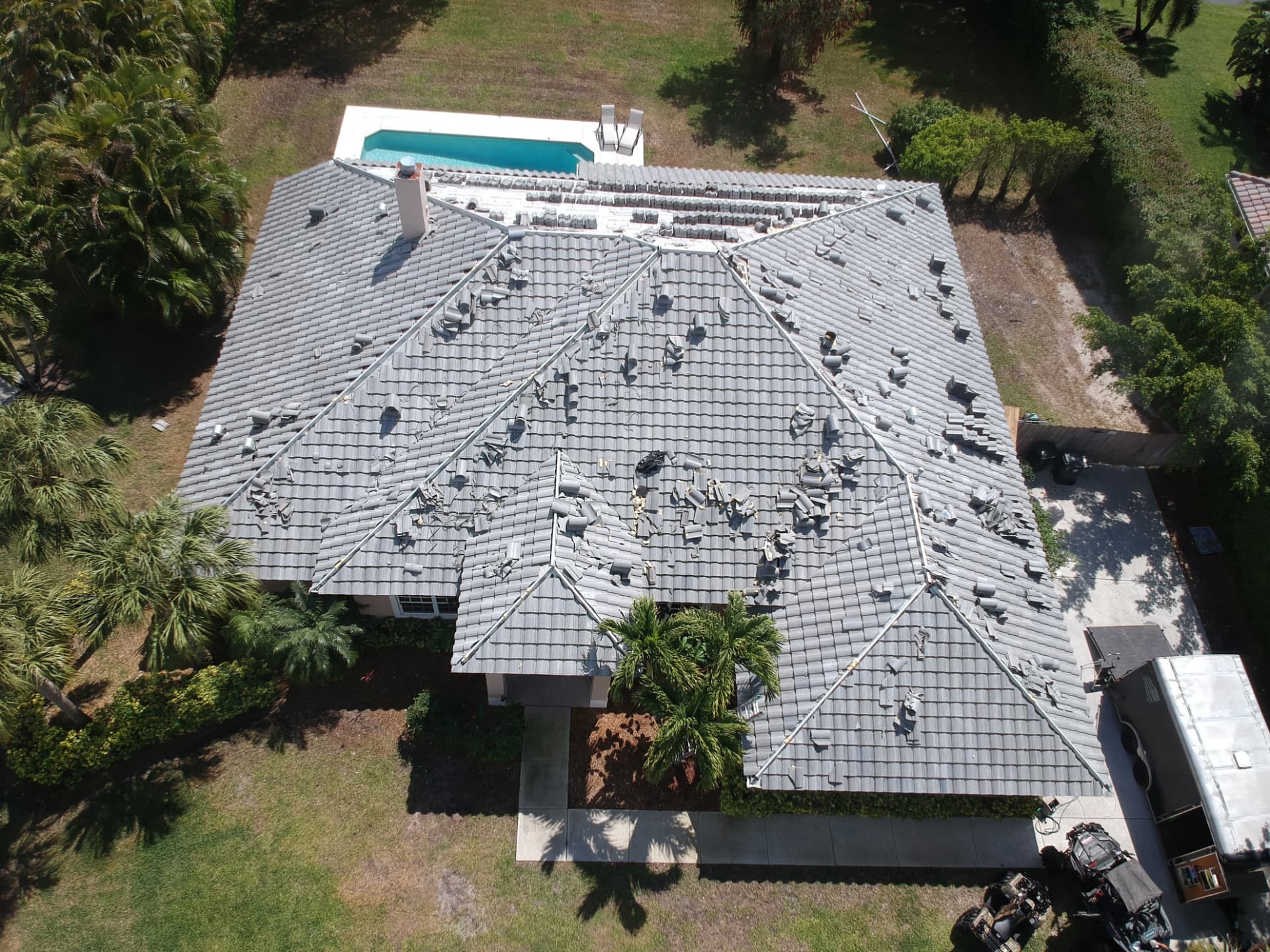 Tile roof replacement in progress with staged tile across the roof planes